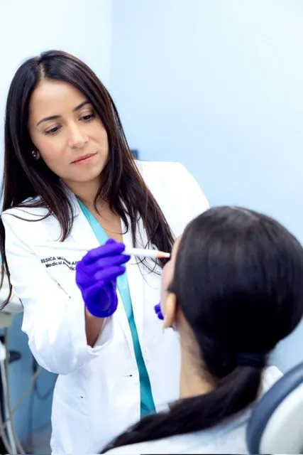 Jessica Valdman, FNP, assessing a patient's facial anatomy during a consultation at Ageless Medical Aesthetics in Hollywood, Florida